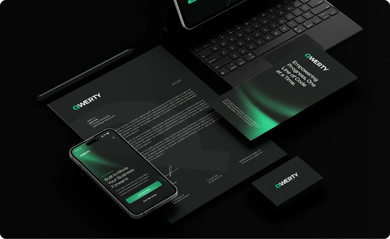 QWERTY letterhead, business cards and phone on a black desk
